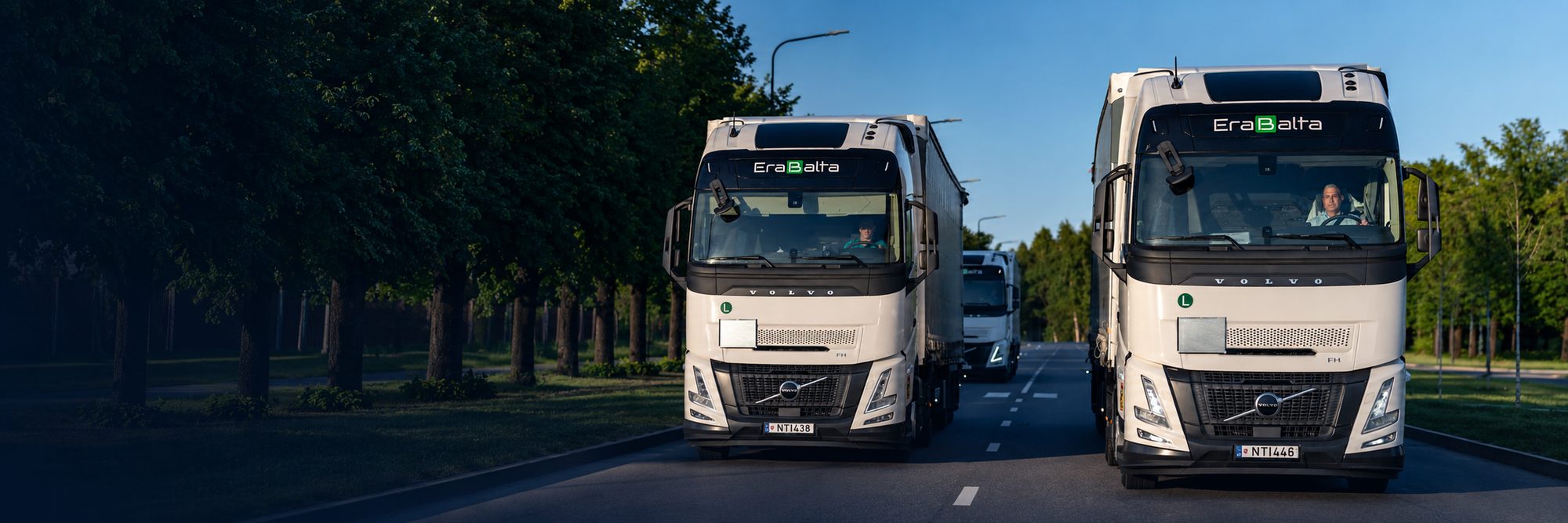 Contact Erabalta: trucks on a tree-lined road