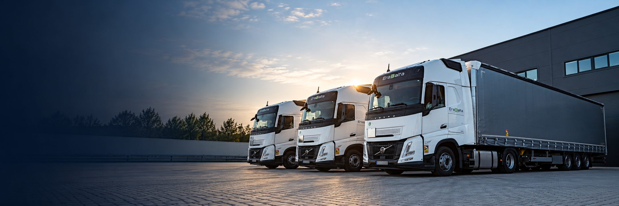 Erabalta news: trucks at a logistics terminal at sunset